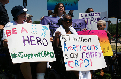Advocates at a CRPD Rally Holding Signs